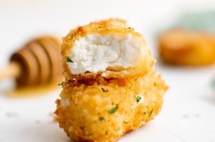 Two pieces of fried goat cheese stacked.